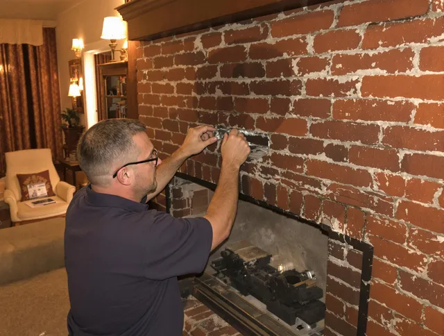 San Clemente Chimney Sweep expert fixing a fireplace in San Clemente, CA